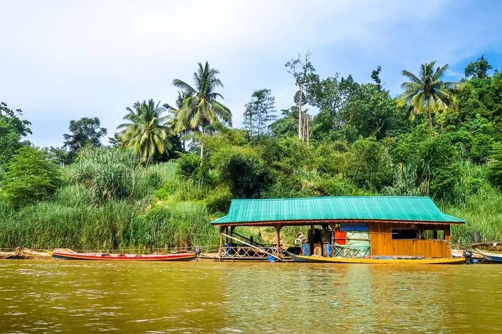 A floating jetty restaurant at Kuala Tahan with longboats moored alongside